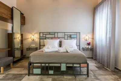 a bedroom with a large bed with white pillows at Casa Maritima in Chania Town