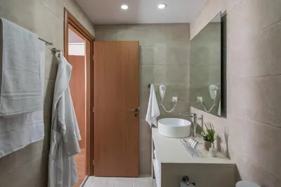 a bathroom with a sink and a mirror at Bluebell Luxury Suites in Chania Town
