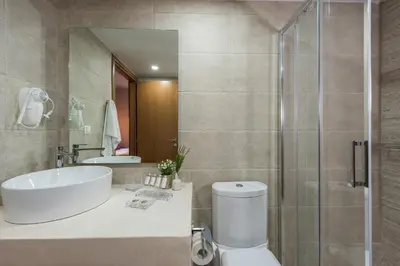 a bathroom with a toilet and a sink and a shower at Bluebell Luxury Suites in Chania Town