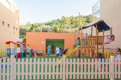 a group of children playing in a playground at Sunrise Village Hotel - All Inclusive in Plataniás