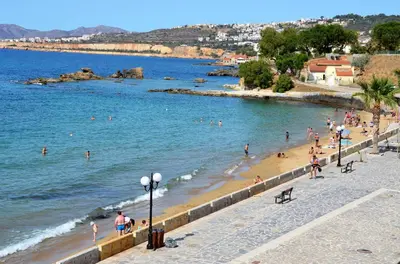 a group of people on a beach near the water at Julies Studios in Chania Town