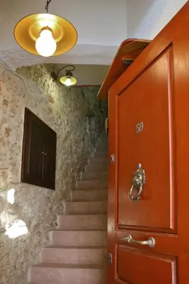 a stairway with a wooden door and a stair case at Casa Alba Seaview House in Chania Town