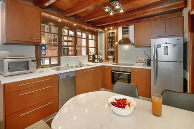 a kitchen with a table with a bowl of fruit on it at Casa Alba Seaview House in Chania Town