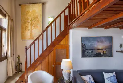 a living room with a staircase with a blue couch at Casa Alba Seaview House in Chania Town