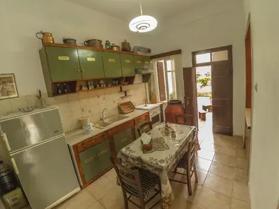 a kitchen with a table and a refrigerator at Venezian Castle House in Kissamos