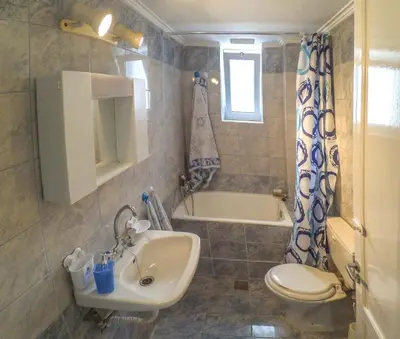 a bathroom with a sink and a toilet and a tub at Venezian Castle House in Kissamos