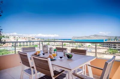 a table and chairs on a balcony with a view of the ocean at Lavender Villas Chania in Agia Marina Nea Kydonias