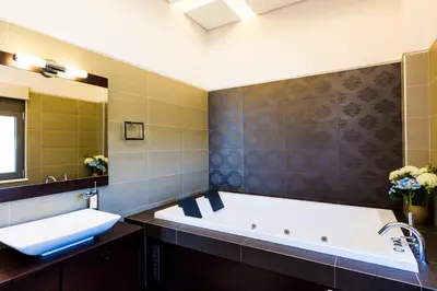 a large bathroom with a tub and a sink at Winehill Villa in Plataniás