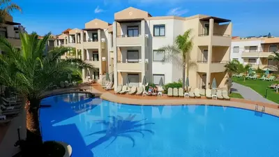 a large swimming pool in front of a building at Creta Palm Resort Hotel & Apartments in Stalos