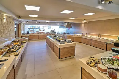 a large kitchen with a buffet line of food at Creta Palm Resort Hotel & Apartments in Stalos