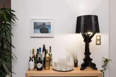 a table with bottles of wine and a lamp on it at Villa Emanuele in Gerani Chanion