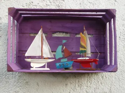 a wooden shelf with three toy boats on it at Aris Apartments in Gerani Chanion