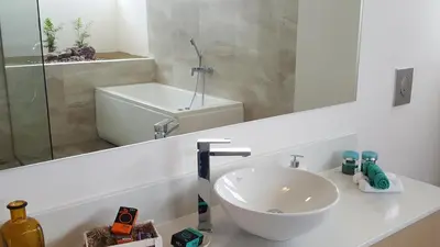 a bathroom with a sink and a mirror at Sea Queen Villa in Kato Daratso