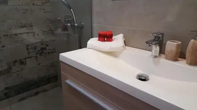 a bathroom with a white sink and a shower at Sea Queen Villa in Kato Daratso