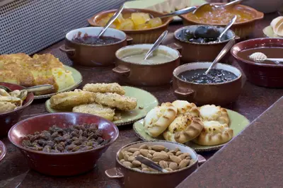 a table full of different types of food on plates at Thalassa Beach Resort & Spa (Adults Only) in Agia Marina Nea Kydonias