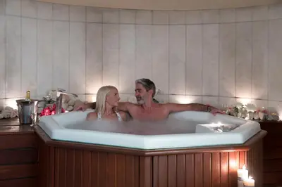 a man and woman sitting in a bath tub at Thalassa Beach Resort & Spa (Adults Only) in Agia Marina Nea Kydonias