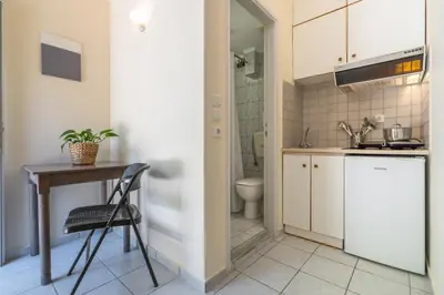 a small kitchen with a table and a sink at Geana Apartments in Chania Town