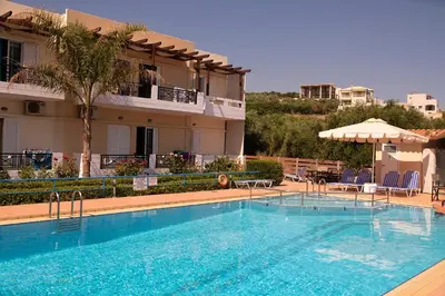 a large swimming pool in front of a building at Niriides in Almirida