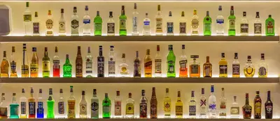 a shelf filled with lots of bottles of alcohol at Corinna Mare in Kalamaki Chanion