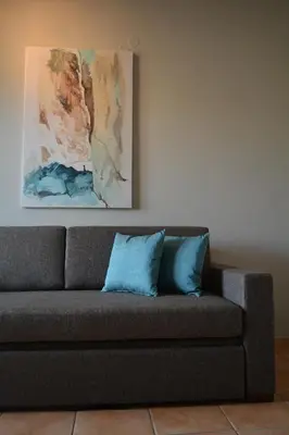 a couch in a living room with a painting on the wall at Corinna Mare in Kalamaki Chanion