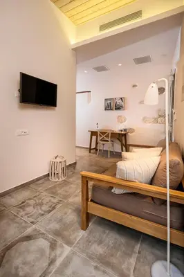 a living room with a bed and a table at Casa di Gouto in Chania Town