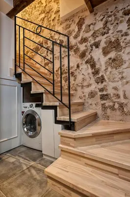 a staircase in a room with a washing machine at Casa di Gouto in Chania Town