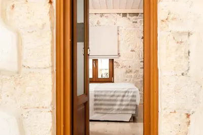 a glass door leading into a room with a table at Casa di Gouto in Chania Town