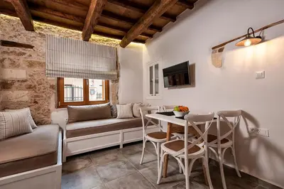 a living room with a table and a couch at Casa di Gouto in Chania Town