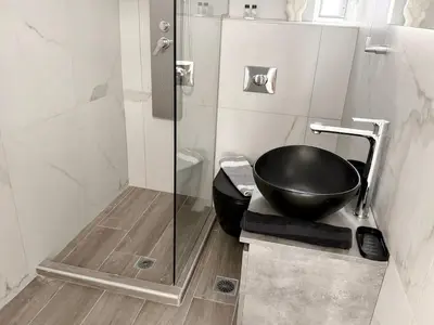 a bathroom with a sink and a toilet and a shower at Sotoportego in Chania Town