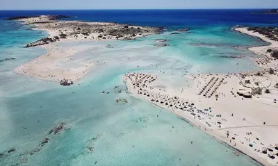 an aerial view of a beach with people in the water at Hostel Stylianos Kissamos in Kissamos
