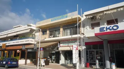a building on the corner of a city street at Hostel Stylianos Kissamos in Kissamos