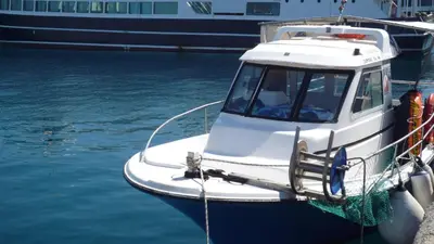 a boat docked at a dock in the water at Hostel Stylianos Kissamos in Kissamos
