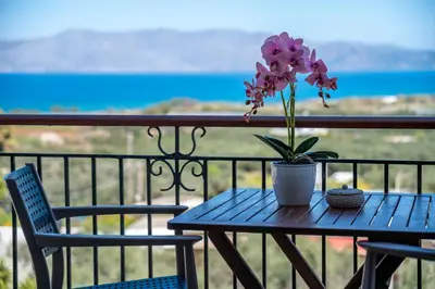 a blue table with a plant on a balcony at Kaliviani Traditional Hotel in Kissamos