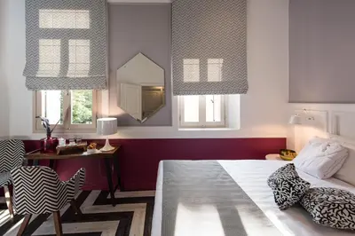 a bedroom with a bed and a table and a mirror at Elia Portou Due in Chania Town