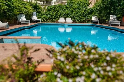 a large blue swimming pool with chairs and chairs at Civitel Akali Hotel in Chania Town