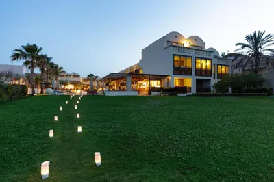 a large building with candles in the grass at Giannoulis - Santa Marina Plaza (Adults Only) in Agia Marina Nea Kydonias