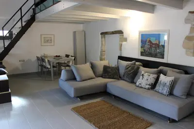 a living room with a couch and a table at Chorio House Platanias in Vrísai