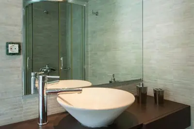 a bathroom with two sinks and a large mirror at Chorio House Platanias in Vrísai