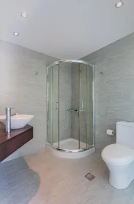 a bathroom with a shower and a toilet and a sink at Chorio House Platanias in Vrísai