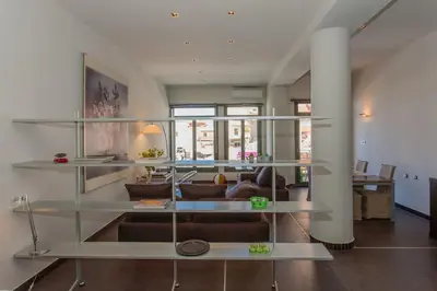 a living room with glass shelves and a couch at Faro Apartments in Chania Town