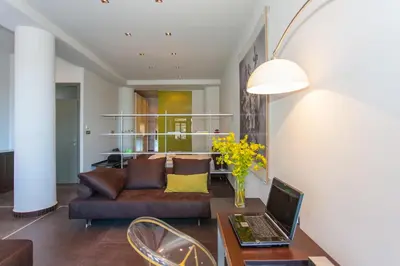 a living room with a couch and a table with a laptop at Faro Apartments in Chania Town