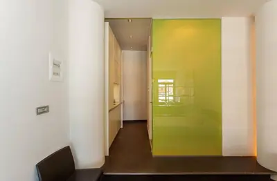 a hallway with a green door in a room at Faro Apartments in Chania Town