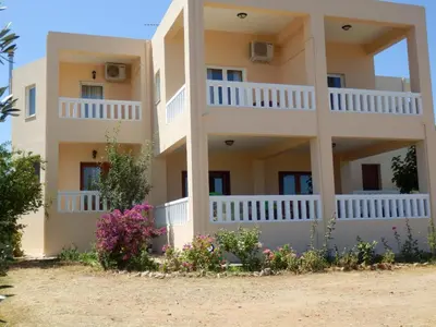 a building with flowers in front of it at Maro Suites in Tavronitis