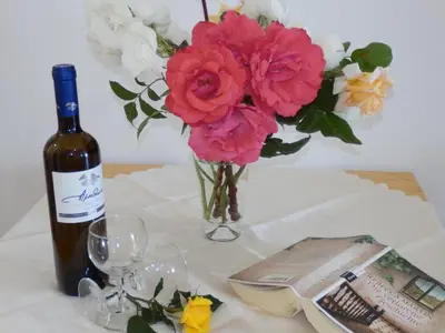 a table with a bottle of wine and a vase of flowers at Maro Suites in Tavronitis