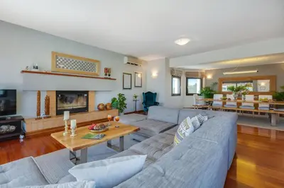 a living room with a couch and a fireplace at Villa Ampelaki - Premium Villa with heated pool in Kounoupidhianá