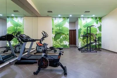 a gym with two treadmills and two exercise bikes at Iolida Beach by Smile Hotels in Agia Marina Nea Kydonias