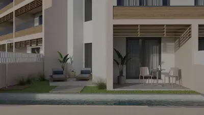 a building with a patio with chairs and a table at Iolida Beach by Smile Hotels in Agia Marina Nea Kydonias