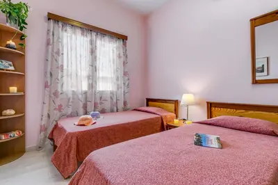 a room with two beds and a window at Agapi Studios in Kato Daratso