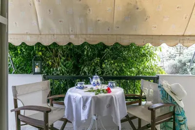 a table with a white table cloth on a patio at Agapi Studios in Kato Daratso