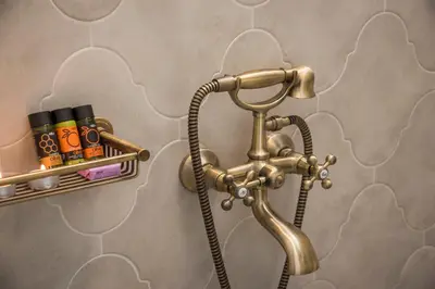 a bathroom with a brass faucet and a sink at Casa Regina Luxury House in Chania Town